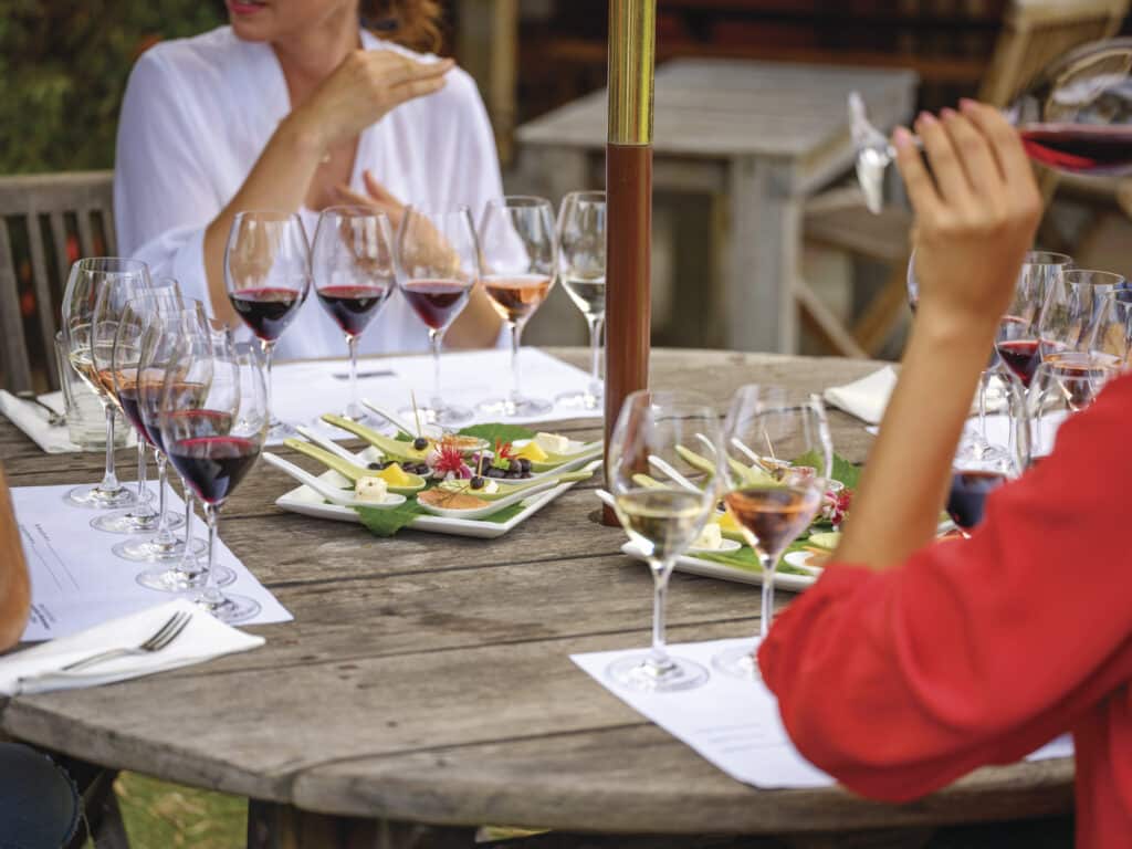 Couples enjoying a wine flight experience at Oranje Tractor Wines, near Albany