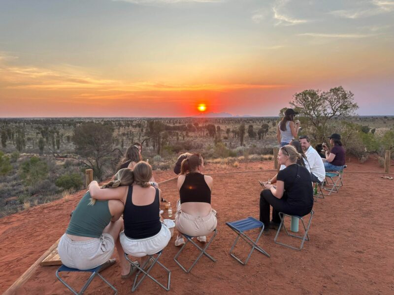 Group of passengers watching sunset in the Red Centre on Uluru tours